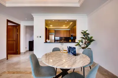 a dining room with a table and chairs at Harmony Vacation Homes - South Residence in Dubai