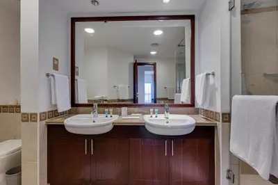 a bathroom with two sinks and a large mirror at Harmony Vacation Homes - South Residence in Dubai