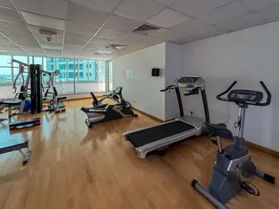 a gym with several exercise bikes in a room at Frank Porter - Panoramic Tower in Dubai