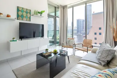 a living room with a couch and a tv at Frank Porter - Panoramic Tower in Dubai
