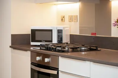 a microwave oven sitting on top of a kitchen counter at HiGuests - Unique Studio With Stunning Panoramic Marina Views in Dubai