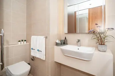 a bathroom with a sink and a toilet and a mirror at HiGuests - Unique Studio With Stunning Panoramic Marina Views in Dubai