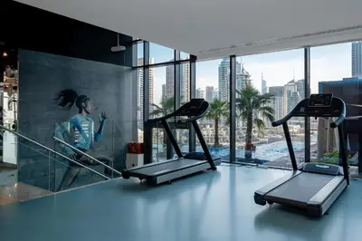 a gym with two treadmills in a building at HiGuests - Unique Studio With Stunning Panoramic Marina Views in Dubai