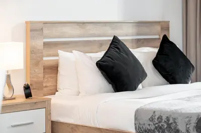 a bedroom with a bed with black and white pillows at HiGuests - Unique Studio With Stunning Panoramic Marina Views in Dubai