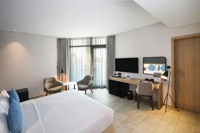 a hotel room with a bed and a desk at Beach Walk Hotel Jumeirah in Dubai