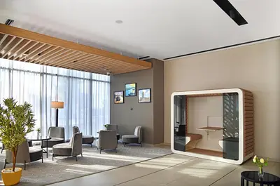a lobby with a waiting room with chairs and a mirror at Beach Walk Hotel Jumeirah in Dubai
