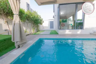 a swimming pool in front of a house at 5 bedroom Villa - Dubai Hills in Dubai