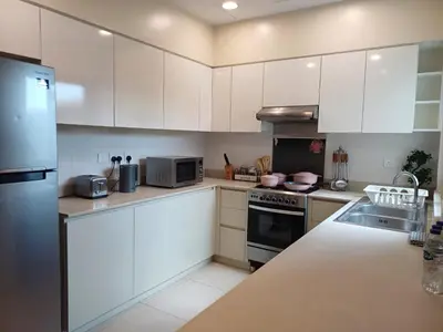 a kitchen with white cabinets and stainless steel appliances at 5 bedroom Villa - Dubai Hills in Dubai