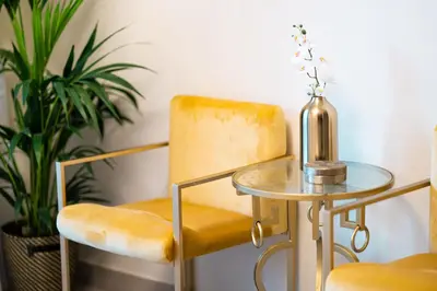 a table and two chairs and a bottle on a table at Elite Royal Apartment - Onyx in Dubai