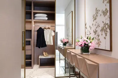 a dressing room with a walk in closet and a dressing table at Al Jaddaf Rotana Dubai in Dubai