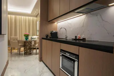 a kitchen with a sink and a counter top at Al Jaddaf Rotana Dubai in Dubai