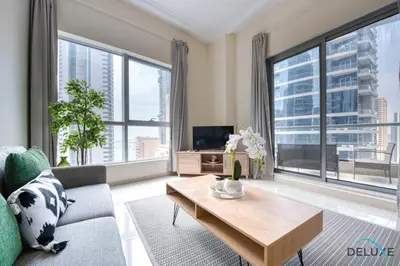 a living room with a couch and a table at Overlooking Marina Canal 1BR Close to Mall, Promenade & Beach, Bay Central 1, Dubai Marina by Deluxe Holiday Homes in Dubai