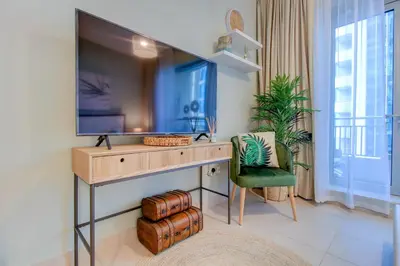 a room with a desk with a tv and a chair at Durrani Homes - Luxurious Studio near Dubai Mall with pool view in Dubai