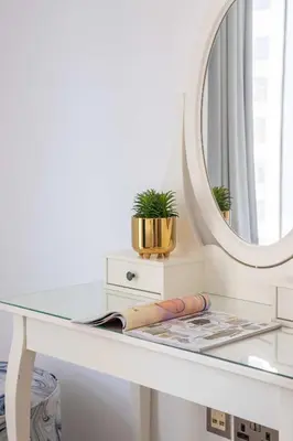 a dressing table with a mirror on top of it at Frank Porter - Trident Grand in Dubai