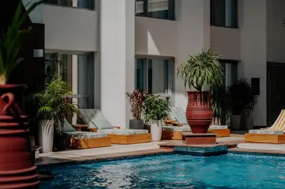a pool with a large vase next to a building at Dusit Thani Dubai in Dubai