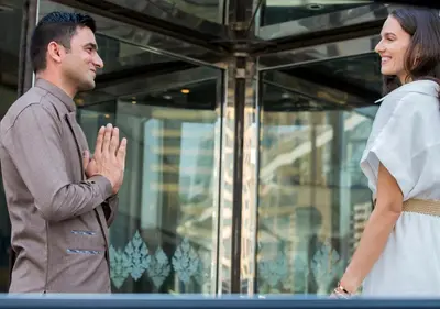 a man and a woman standing in front of a window at Dusit Thani Dubai in Dubai