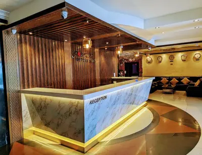 a lobby of a restaurant with a reception desk at Fortune Karama Hotel in Dubai