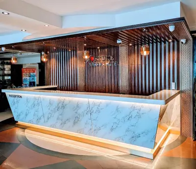 a bar in a lobby with a marble counter at Fortune Karama Hotel in Dubai