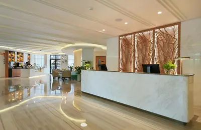 a lobby with a reception desk in a building at Arabian Park Dubai, an Edge by Rotana Hotel in Dubai