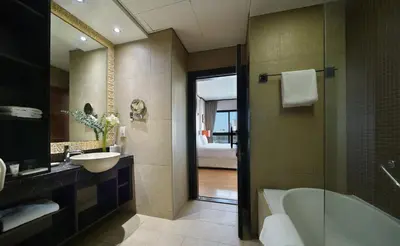 a bathroom with a tub and a sink and a mirror at Park Apartments Dubai, an Edge By Rotana Hotel in Dubai