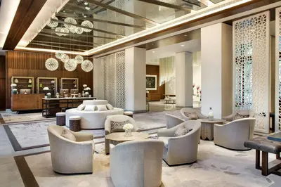 a lobby with couches and chairs and a table at The Heritage Hotel, Autograph Collection, Downtown Dubai in Dubai