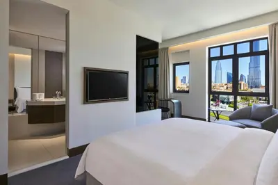 a hotel room with a large bed and a television at The Heritage Hotel, Autograph Collection, Downtown Dubai in Dubai