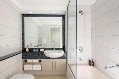 a bathroom with a sink and a tub and a mirror at Staybridge Suites Dubai Financial Centre by IHG in Dubai