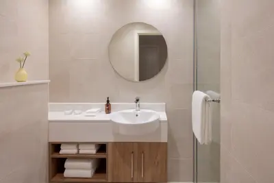 a bathroom with a sink and a mirror at Staybridge Suites Dubai Financial Centre by IHG in Dubai