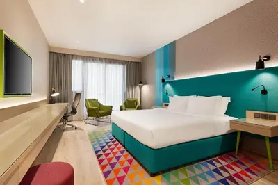 a colorful hotel room with a bed and a tv at La Quinta by Wyndham Dubai Jumeirah in Dubai