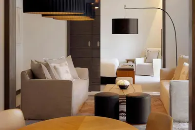 a living room with two chairs and a table at Hotel Boulevard, Autograph Collection, Downtown Dubai in Dubai