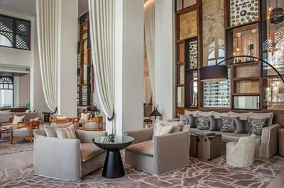 a lobby with couches and chairs and a table at Hotel Boulevard, Autograph Collection, Downtown Dubai in Dubai