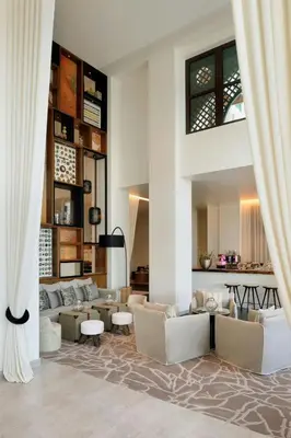 a living room with couches and tables at Hotel Boulevard, Autograph Collection, Downtown Dubai in Dubai