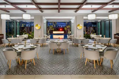 a restaurant with tables and chairs in a room at Hotel Boulevard, Autograph Collection, Downtown Dubai in Dubai