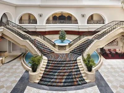 a spiral staircase in a building with a lobby at Mövenpick Hotel & Apartments Bur Dubai in Dubai