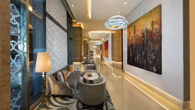 a lobby of a hotel with a large painting on the wall at Kempinski Hotel Mall of the Emirates, Dubai in Dubai