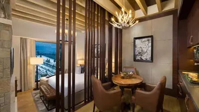 a hotel room with a bed and a table and chairs at Kempinski Hotel Mall of the Emirates, Dubai in Dubai