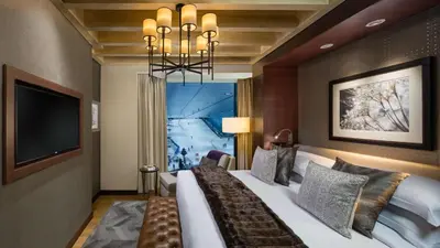 a bedroom with a large bed and a television at Kempinski Hotel Mall of the Emirates, Dubai in Dubai