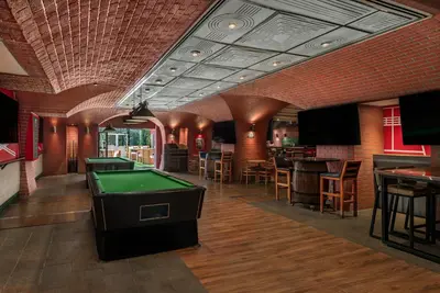 a billiard room with a pool table and a bar at Al Habtoor Grand Resort, Autograph Collection in Dubai