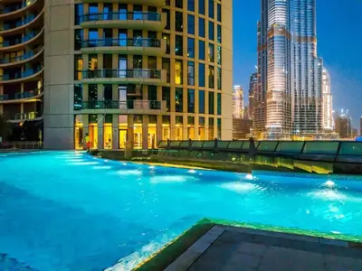 a swimming pool in a city with tall buildings at Spacious 3BR in Downtown, Direct Access to Dubai Mall & Metro, Burj Khalifa Views in Dubai
