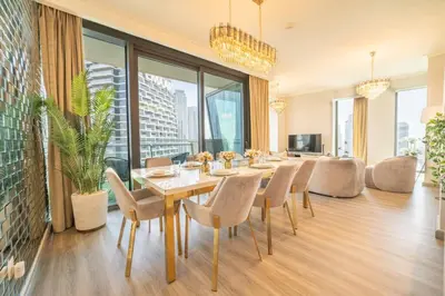 a dining room with a table and chairs at Spacious 3BR in Downtown, Direct Access to Dubai Mall & Metro, Burj Khalifa Views in Dubai
