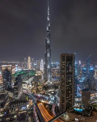 a night view of a city with a tall building at Spacious 3BR in Downtown, Direct Access to Dubai Mall & Metro, Burj Khalifa Views in Dubai