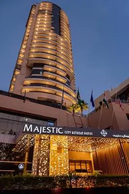 a building with christmas lights in front of it at Majestic City Retreat Hotel in Dubai