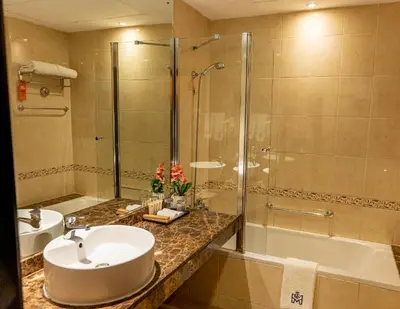 a bathroom with a sink and a shower at Majestic City Retreat Hotel in Dubai