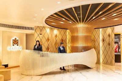 two people standing in the lobby of a hotel at Majestic City Retreat Hotel in Dubai