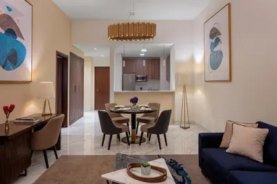 a living room with a blue couch and a table at Avani Plus Palm View Dubai Hotel & Suites in Dubai