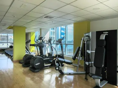 a gym with several treadmills and exercise bikes at The Smart Concierge - Bay Central in Dubai