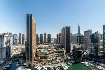 an aerial view of a city with boats in a harbor at The Smart Concierge - Bay Central in Dubai