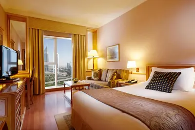 a hotel room with a bed and a large window at Millennium Plaza Downtown, Dubai in Dubai