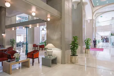 a lobby with chairs and tables in a building at Millennium Plaza Downtown, Dubai in Dubai