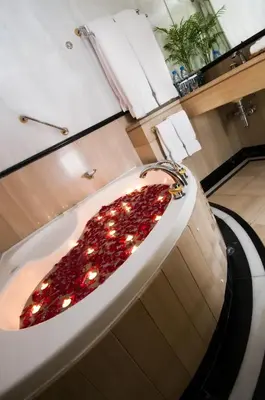 a bath tub with lights in it in a bathroom at Millennium Plaza Downtown, Dubai in Dubai